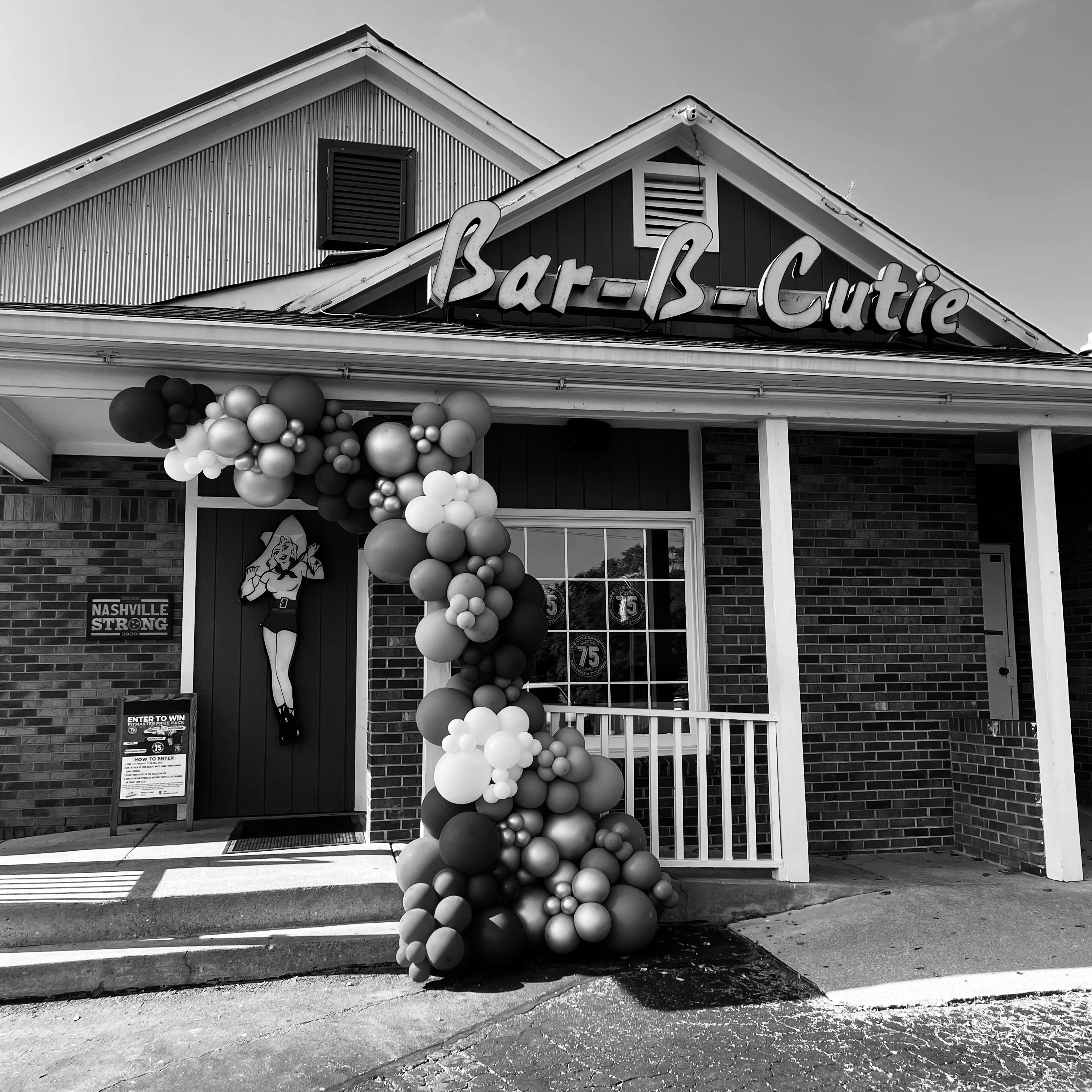 smiling bridesmaids are outside and holding flowers